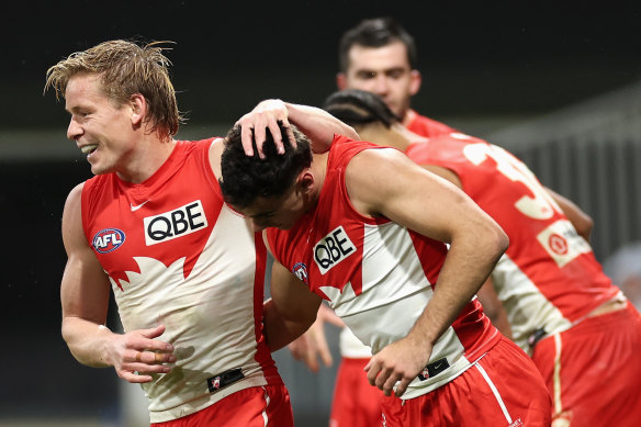 Caiden Cleary of the Swans is congratulated by Isaac Heeney.