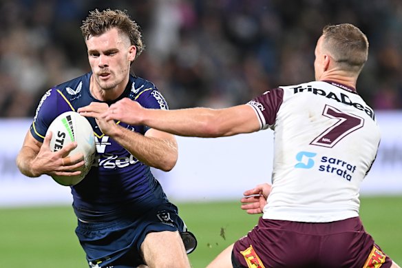 Papenhuyzen tries to slip the tackle of Daly Cherry-Evans.
