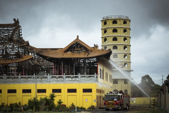 Firefighters put out spot fires at the Buddhist temple in Springvale on Monday morning. 