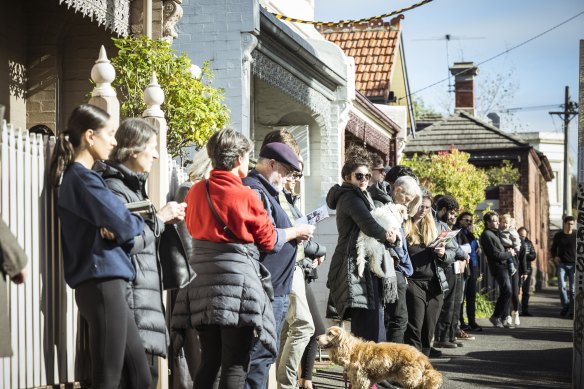 A large crowd gathered to watch the sale of 124 Lee Street. 