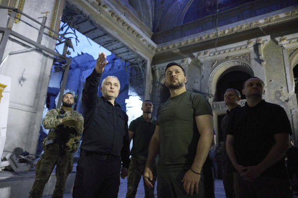 Ukrainian President Volodymyr Zelensky (centre right) inspects damage of the Odesa Transfiguration Cathedral in Odesa in July.