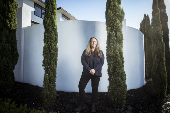 Diana Tamis and the white fence that was built on council land.