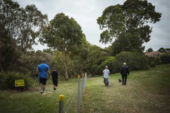 One small section of fencing between golfers and walkers.