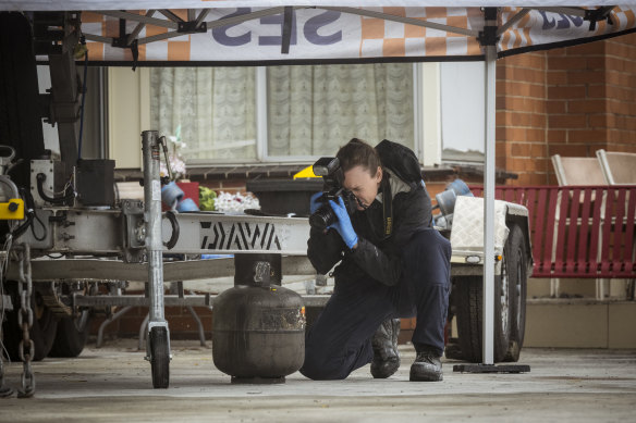 An investigator on the scene where a car was burnt out and shots allegedly fired at a home in Fawkner with links to crime figure Mohammed Charif Oueida.