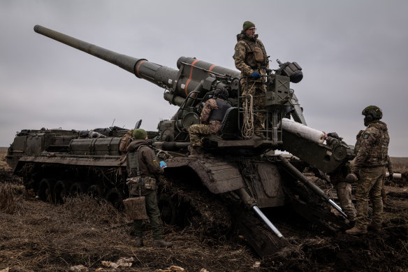 Ukrainian artillerymen fire a 2S7 Pion cannon toward Russian fortifications inside the city of Kreminna.
