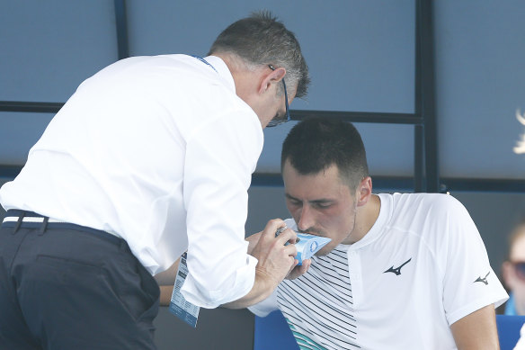 Australian Bernard Tomic using inhaler medication during his match on Tuesday.