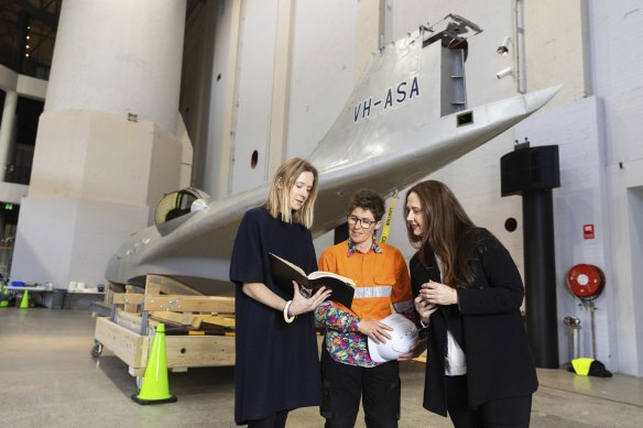 Helen Johnson, Charm Watts and Alison Brennan discuss large Powerhouse items that will be transported from Pyrmont to Albion Park to make way for the renovations.