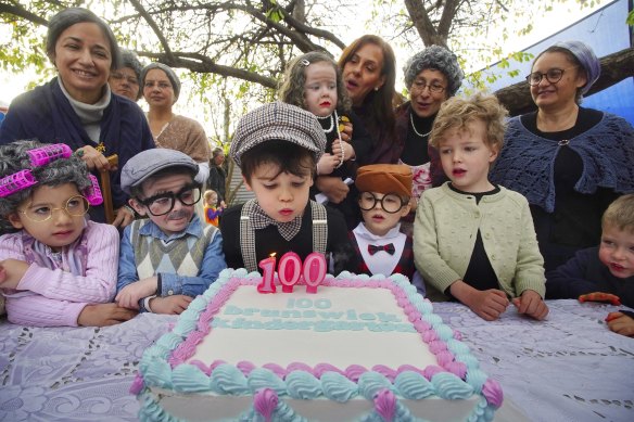 Louis blows out the candles on Brunswick Kindergarten’s 100th birthday cake.