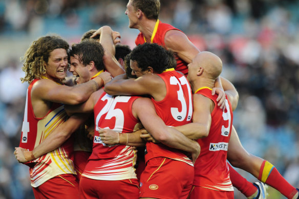 Elated Suns players celebrate after their first ever win.