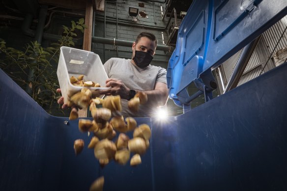Luke Stepsys’ brother, Jason, throwing away food at Feast of Merit in Richmond. 
