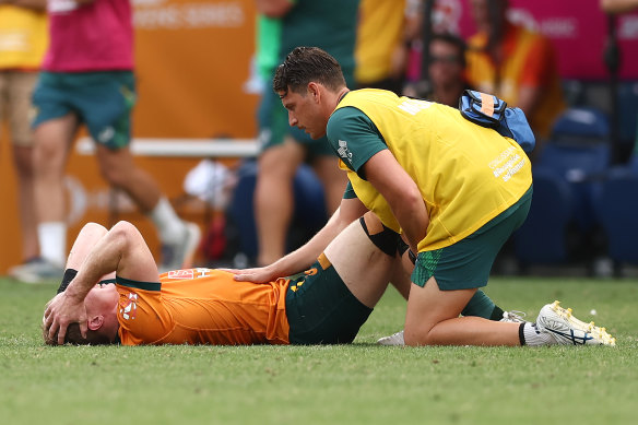 Henry Hutchison receives medical treatment during Australia’s game against Argentina.