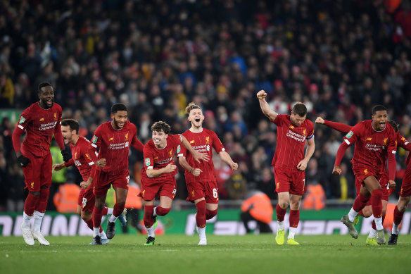 Jubilant Liverpool players enjoy the moment of triumph over Arsenal.