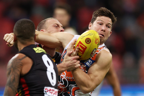 Toby Greene of the Giants is challenged by Callum Wilkie of the Saints.