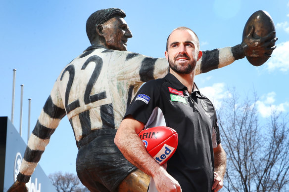 Collingwood’s Steele Sidebottom, who reaches 300 AFL games on Sunday, with the statue of Bob Rose.