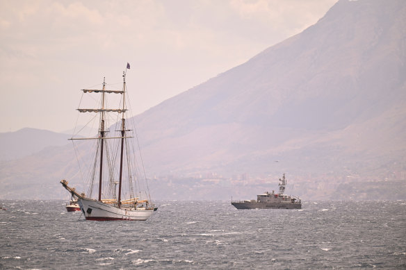 A coastguard vessel and a private sail boat assist the search for missing passengers after a yacht, the Bayesian,  capsized off the coast of Palermo, Italy.