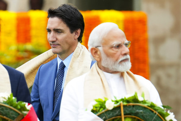 Canada’s Prime Minister Justin Trudeau, left, walks past Indian Prime Minister Narendra Modi as they take part in a wreath-laying ceremony at Raj Ghat, Mahatma Gandhi’s cremation site, during the G20 Summit earlier this month.