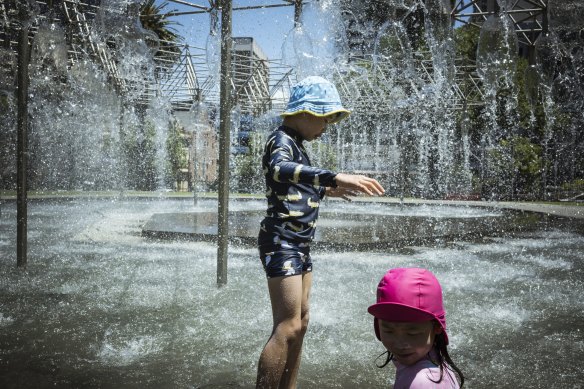 On a sweltering day in Melbourne, Nathan 7, and sister Emma, 4, cooled off at Coles Fountain.