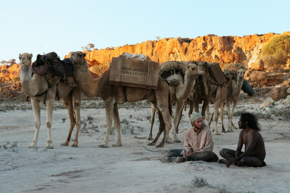Hanif (Ahmed Malek), Woorak (Baykali Gnambarr) and camel train in a scene from Roderick MacKay's The Furnace. 