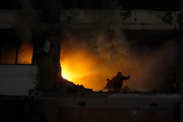 People search for survivors inside an apartment following a massive explosion in the southern Beirut suburb of Dahiyeh, Lebanon.