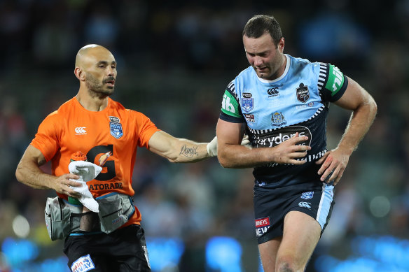 Boyd Cordner is assisted off Adelaide Oval for a head injury assessment.