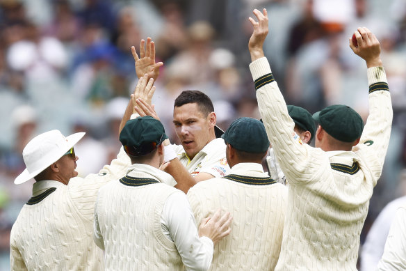 Scott Boland celebrates the dismissal of Kyle Verreynne with teammates.