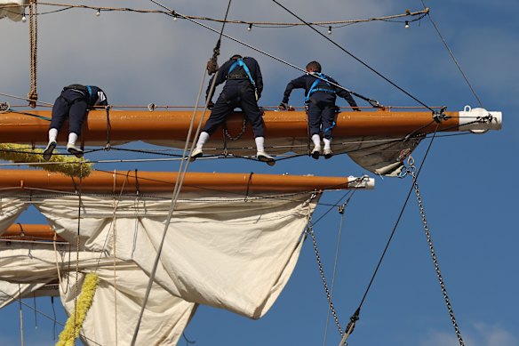 Sailors work on the yard arms of the stranded  Cuauhtémoc.