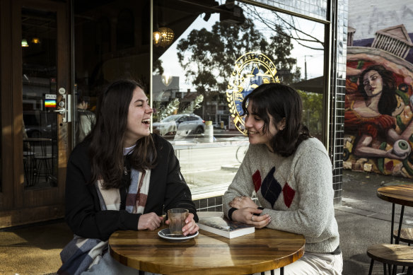 Friends Madeline Sergeant (left) and Maya Honey-Holmes catch up.