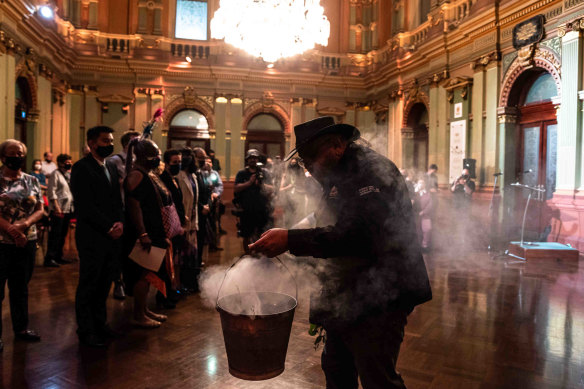 Brendan Kerin from the Metropolitan Local Aboriginal Land Council conducts a smoking ceremony at Town Hall on Thursday.