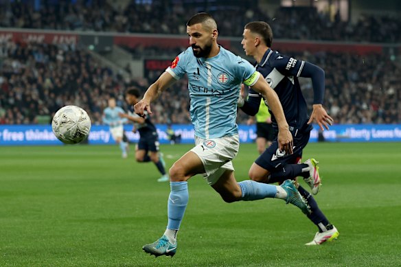 Melbourne City captain Aziz Behich runs down the sideline.