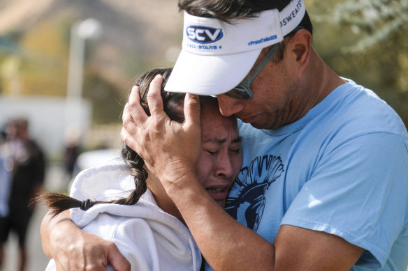 Ella Cabigting is embraced by her father Emerson as they reunite after the shooting at Saugus High School.