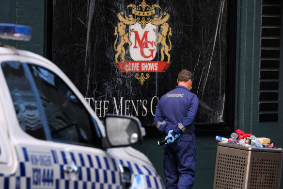 Police collect evidence at the Men’s Gallery on Sunday morning.