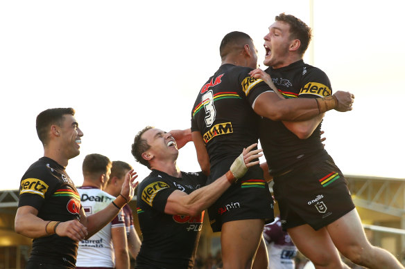 Stephen Crichton celebrates with teammates after scoring a try.