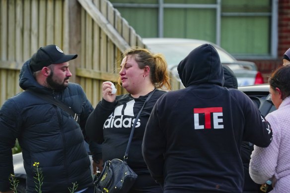 Grieving family members outside the Broadmeadows home where four people were found dead.