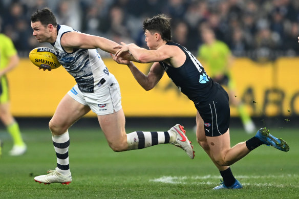 Patrick Dangerfield attempts to get away from the Blues’ Sam Walsh.