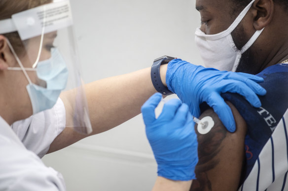 A pharmacist administers the Pfizer COVID-19 vaccination in Jackson, Mississippi. 