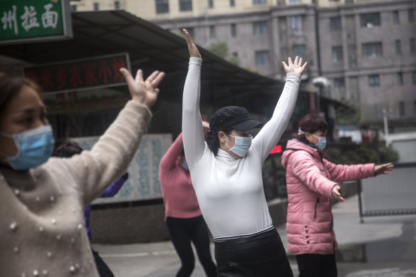 An exercise class in Wuhan continues in spite of the march of the deadly virus.