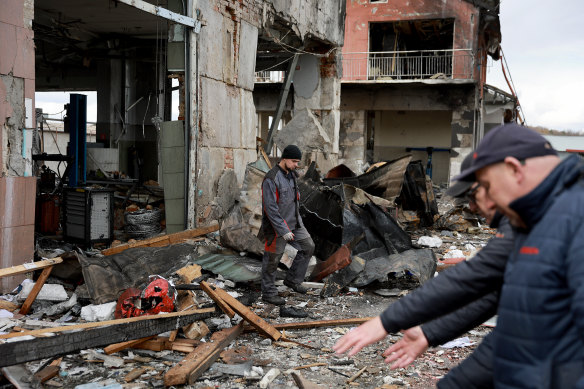 A worker walks through what remains of the premises he worked at after it was hit by a Russian missile in Lviv.