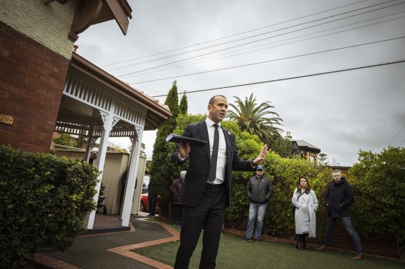 Auctioneer Jayson Watts in action. The home received just two bids before passing in and later selling.