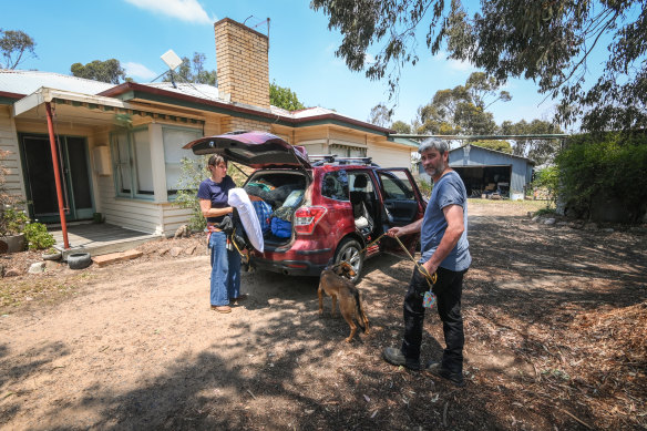 Anthi Emmanouil-Playne and Bill Playne, with dog Remi, pack up their car to leave Pomonal on Christmas Eve.