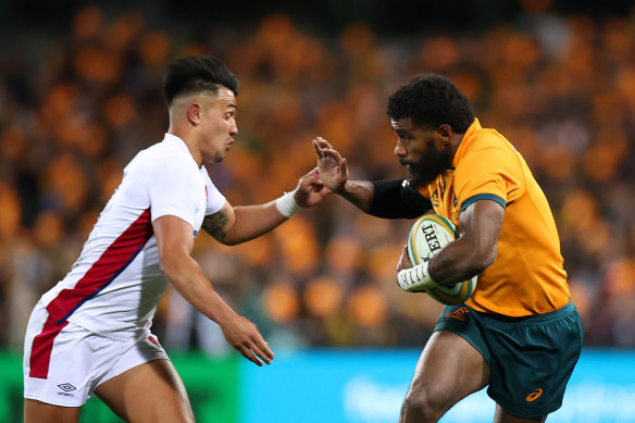 Wallabies winger Marika Koroibete taking on England’s Marcus Smith.