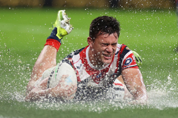 Joseph Manu crosses a very wet try line.