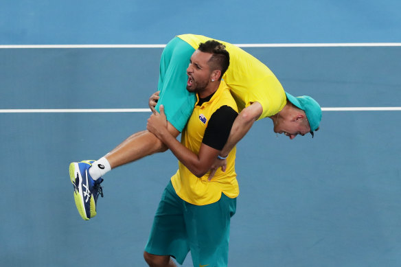 Nick Kyrgios carrying Alex de Minaur  after the win over Great Britain at the ATP Cup in 2020.