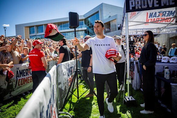 Charlie Kirk hands out hats on the day he was shot dead at Utah Valley University.