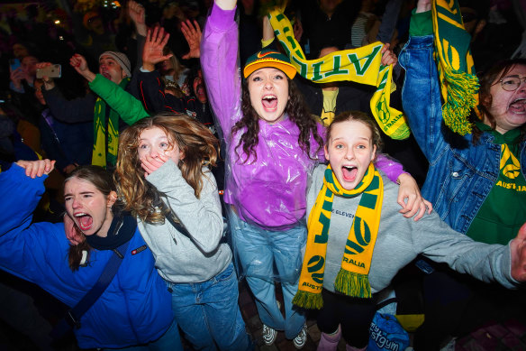 Jubilant fans celebrate the Matildas’ win at Melbourne’s Federation Square.