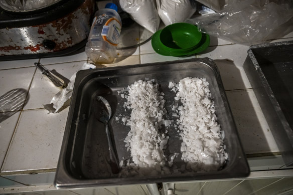 A tray of crystal flakes that a Sinaloa cartel cook said was a chemical called sodium hydroxide, a key fentanyl ingredient, sits on a countertop in Culiacan, Mexico.