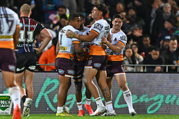 Broncos players celebrate a try.