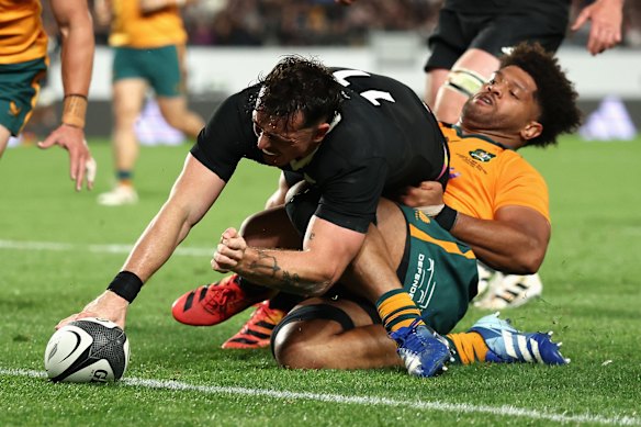 Rob Valetini tackles Leroy Carter from behind at Eden Park.