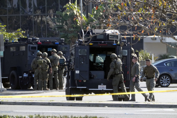 SWAT officers surround a van, suspected to belong to the shooter in Torrance in California.