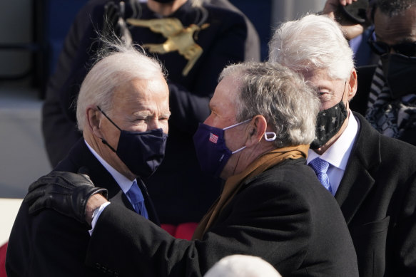 President Joe Biden talks to former presidents George W. Bush and Bill Clinton after the inauguration. 