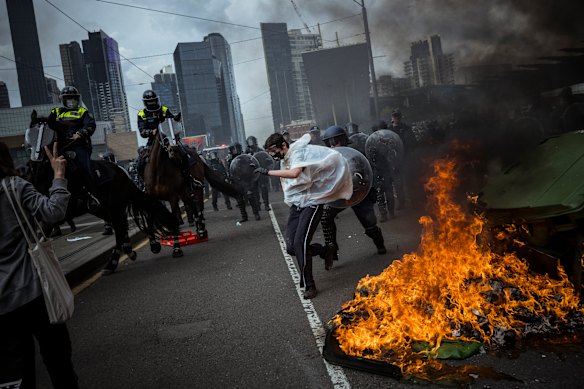 Police force protesters away from the Land Forces expo.